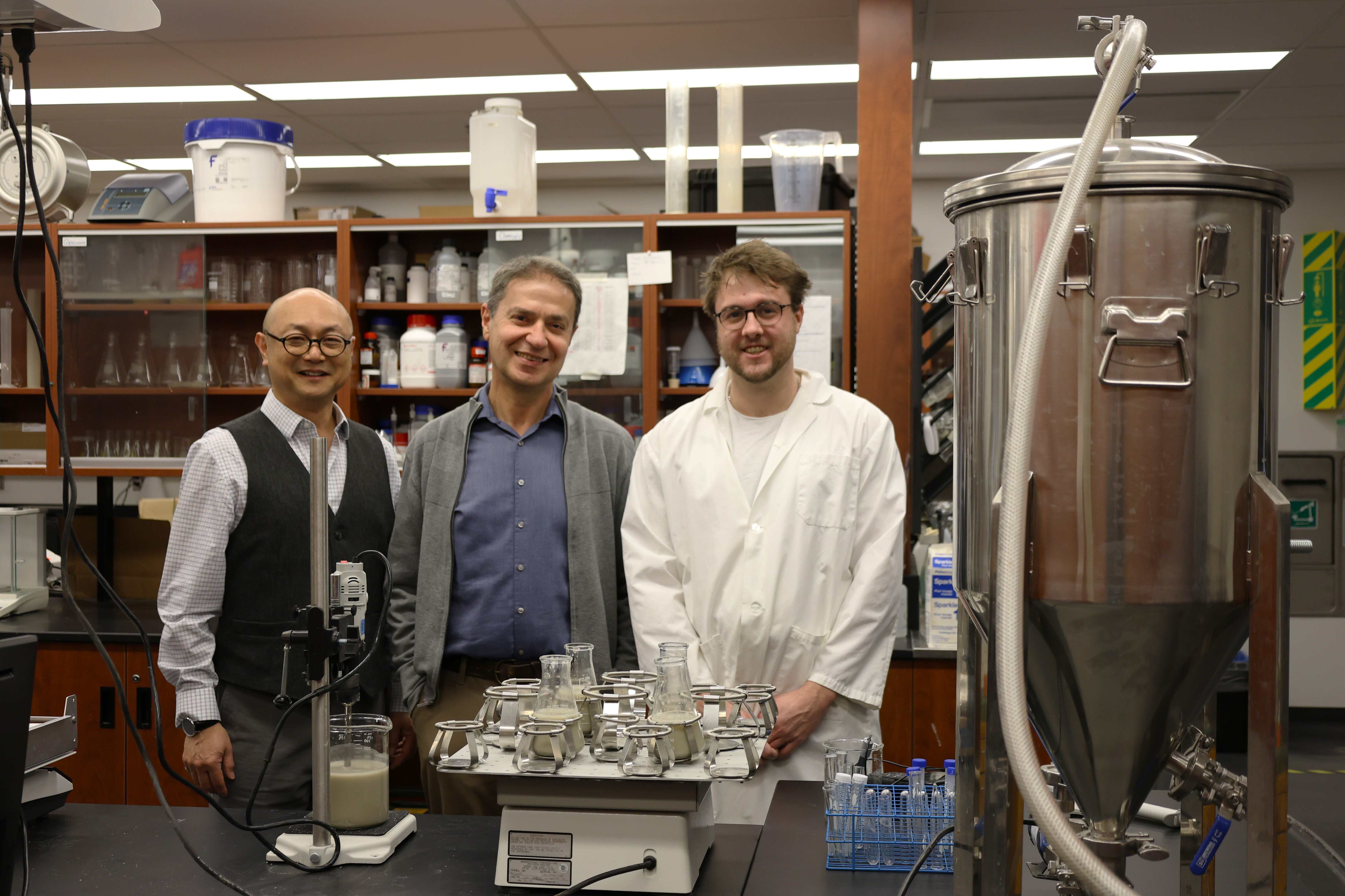 Ping Wu, Dr. Bassim Abbassi, and Anthony Heebner standing in the lab.