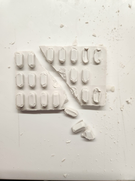 Plaster sculpture of a medication blister pack