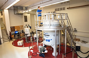 Two graduate students work in the NMR lab at U of G