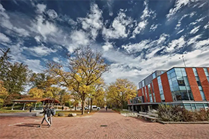 Students walking on campus in front of Thornborough building during fall