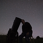 Trevor using equipment looking at night sky